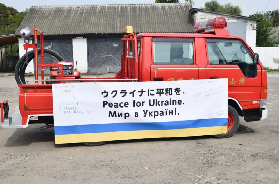Fire engine displaying a banner that wishes for peace